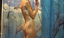 Slim teenage girl shows her naked body in the shower and turns back to the viewer with her back naked